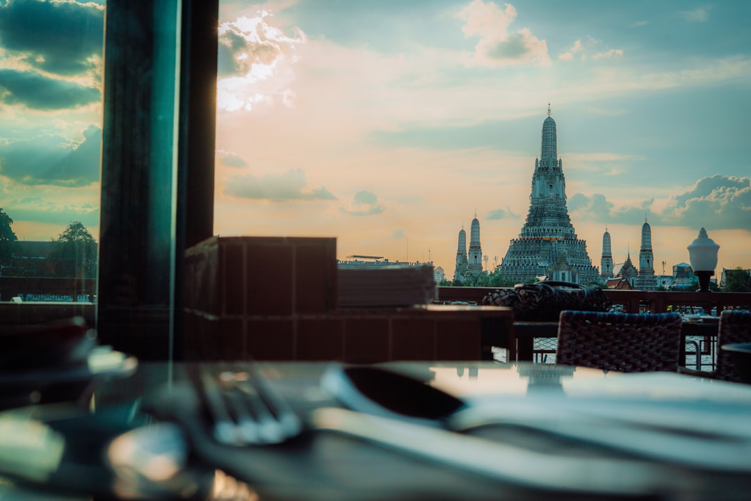 Temple spire against a cloudy sunset sky.